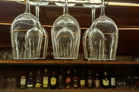 Wine glasses hanging above the lit bar